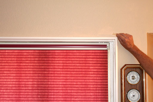 Tape taking sample from top of window frame