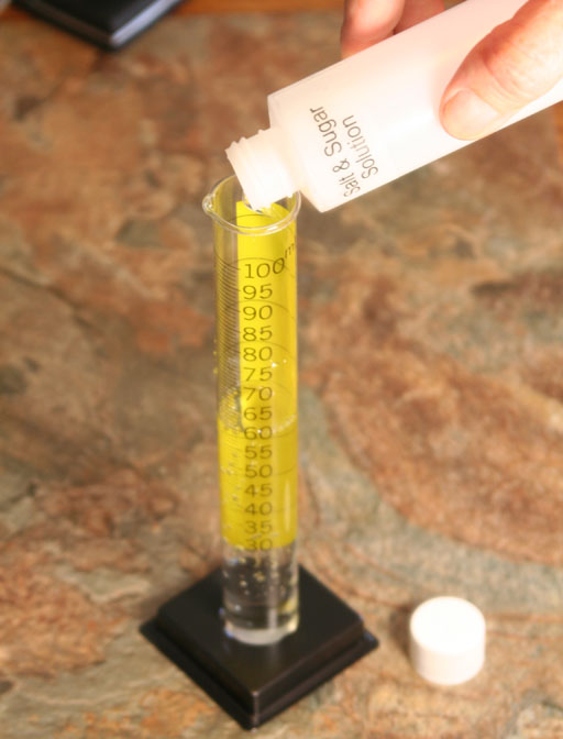 Salt & sugar solution poured into 100 mL graduated cylinder
