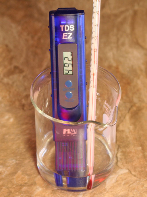 TDS meter in beaker with thermometer