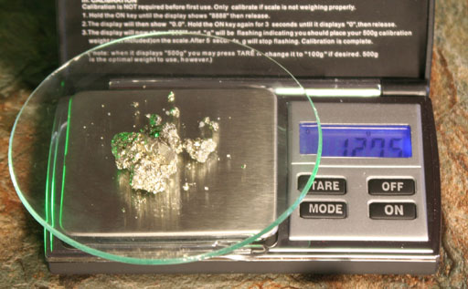 Weighing gold colored mineral