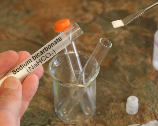 adding sodium bicarbonate to test tube