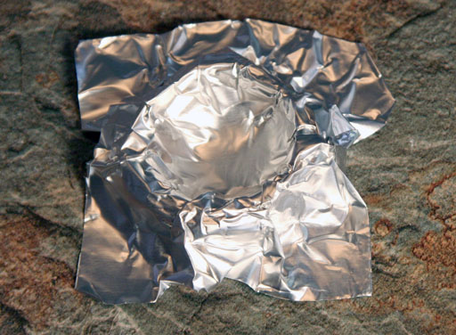 Corners of foil crucible folded flat for legs