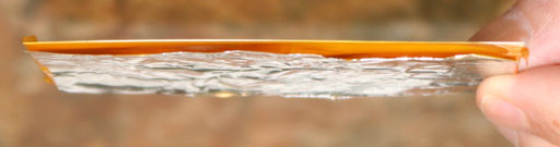 layer of dye-sub film between paper and aluminum foil