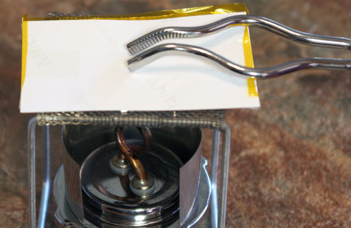 using tongs to push down on top of dye sub sandwich