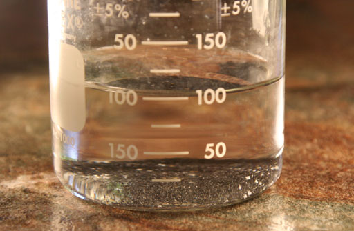 beaker with black sand filled to 100mL