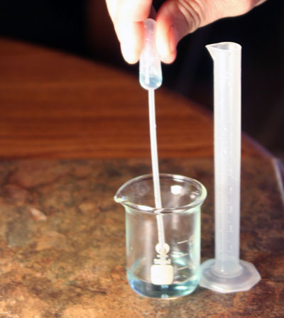 transferring 1 mL copper solution back to the 10 mL grad cylinder