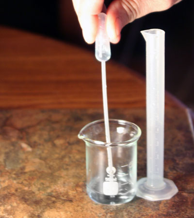transferring 1 mL copper solution back to the 10 mL grad cylinder