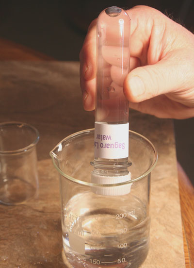 large test tube filled with water near beaker