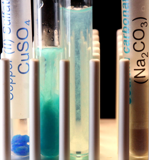 Copper carbonate precipitates in test tubes